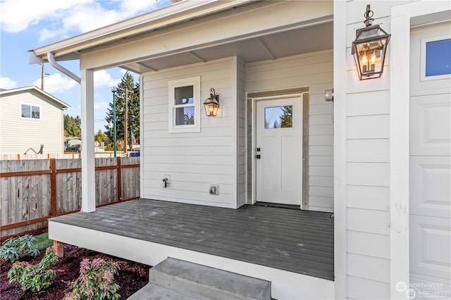 view of exterior entry featuring covered porch