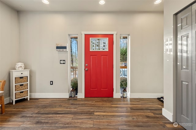 foyer entrance with dark hardwood / wood-style floors