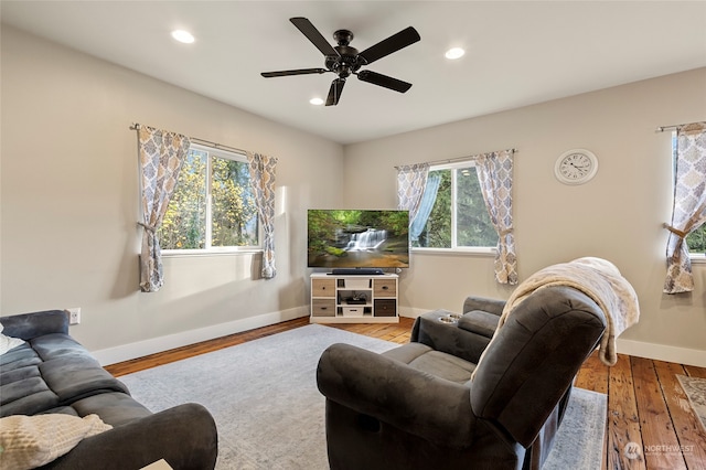 living room with ceiling fan, a wealth of natural light, and light hardwood / wood-style floors