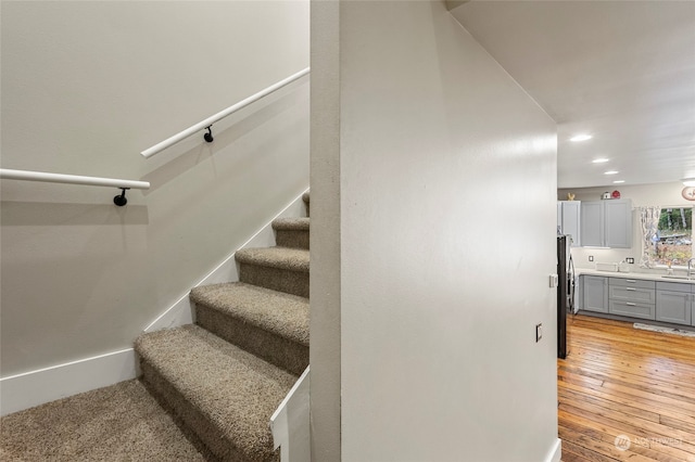 stairs featuring hardwood / wood-style floors