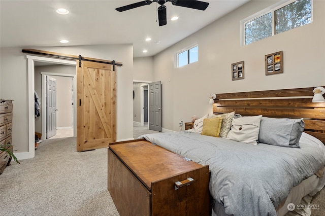 carpeted bedroom featuring ceiling fan, a barn door, and high vaulted ceiling