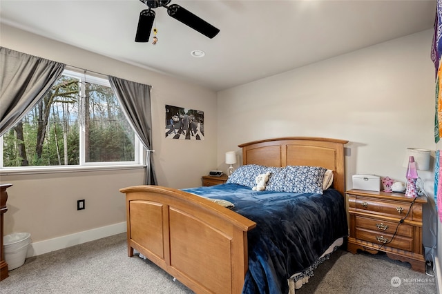 bedroom featuring light colored carpet and ceiling fan