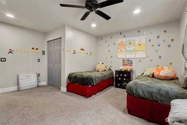 carpeted bedroom with ceiling fan and a closet