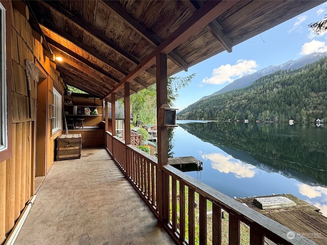 balcony featuring a water and mountain view