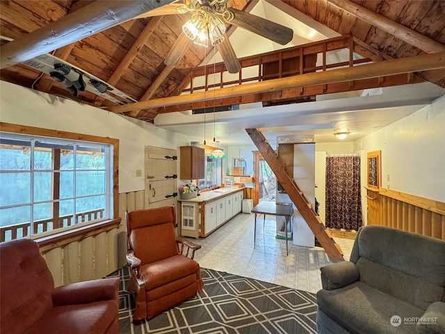 living room with vaulted ceiling with beams, ceiling fan, sink, and wood ceiling