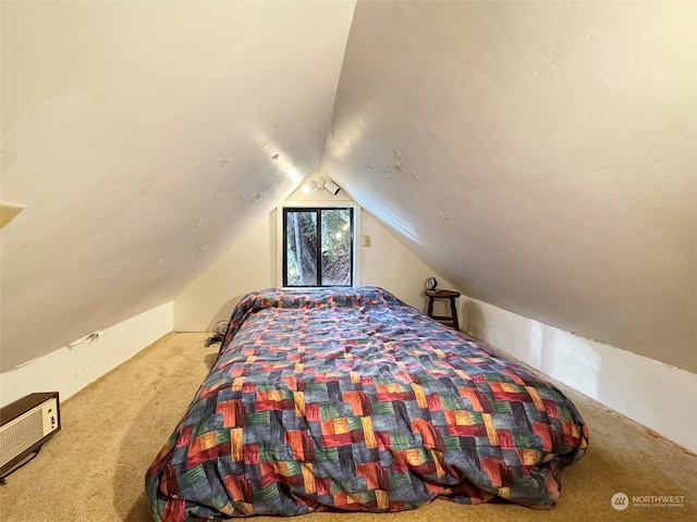 bedroom with carpet and lofted ceiling