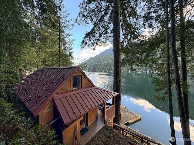 view of dock with a water and mountain view