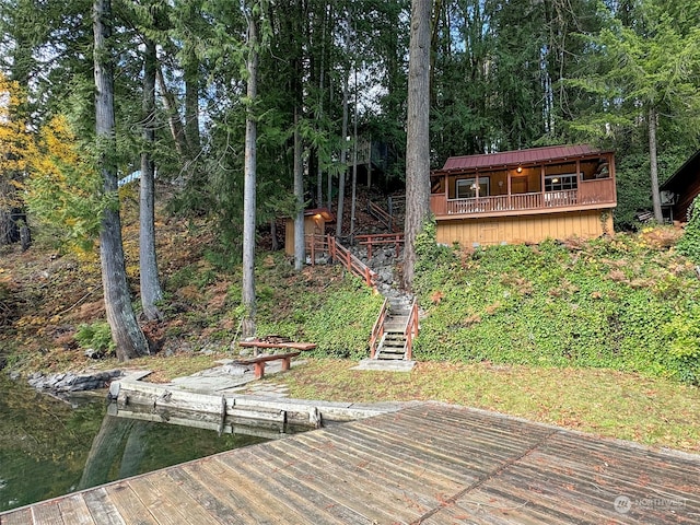 exterior space featuring a boat dock and a water view