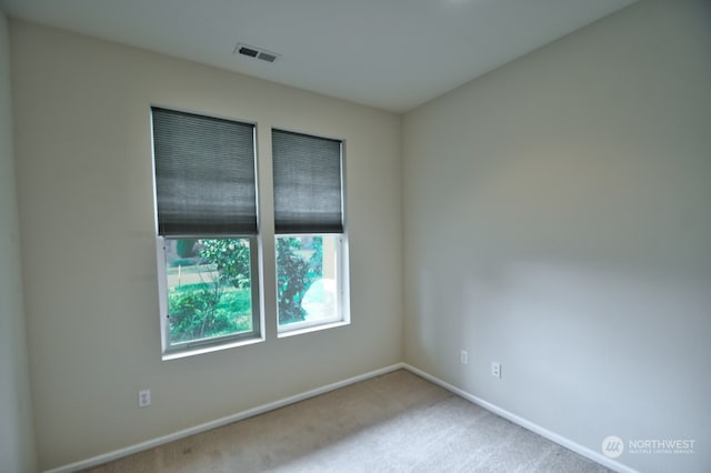 empty room featuring light colored carpet