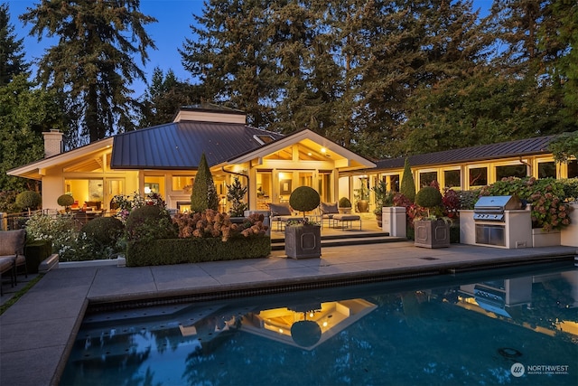 view of pool featuring area for grilling and a patio