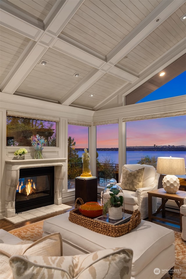 sunroom with a water view and lofted ceiling with beams