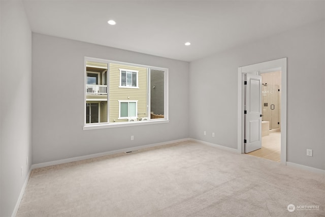 unfurnished room featuring light colored carpet