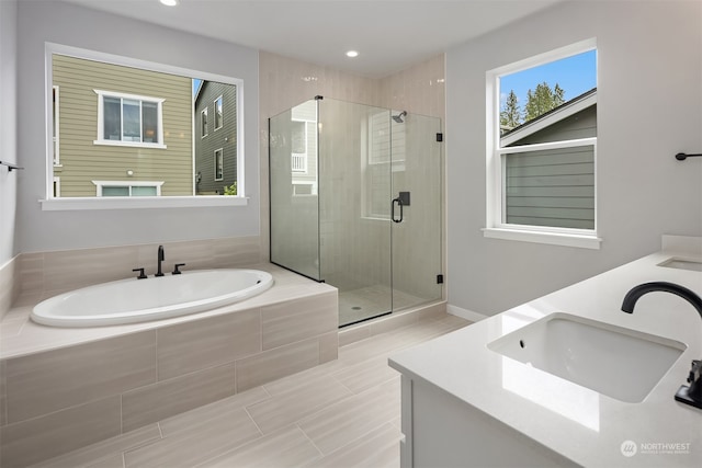 bathroom with vanity and plus walk in shower