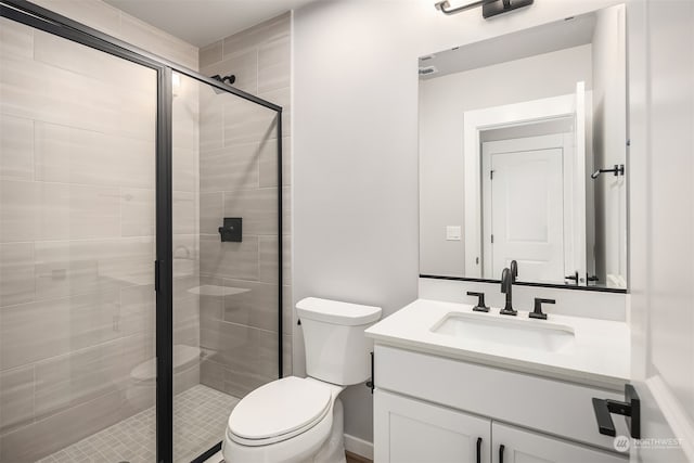 bathroom with vanity, toilet, and an enclosed shower