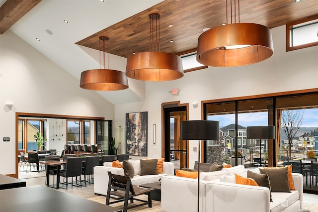 living room with a wealth of natural light, high vaulted ceiling, and wood ceiling