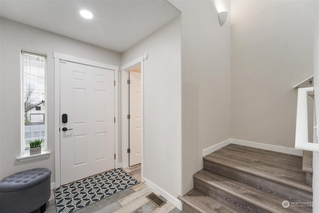 foyer entrance featuring a healthy amount of sunlight and hardwood / wood-style flooring