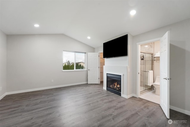 unfurnished living room with hardwood / wood-style flooring and lofted ceiling