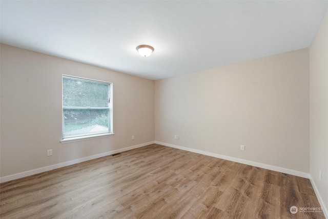 empty room with light hardwood / wood-style flooring