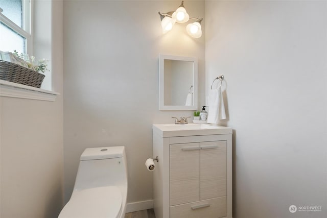 bathroom featuring vanity and toilet