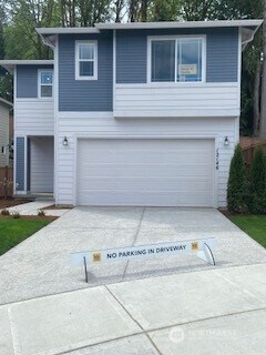 view of front of home with a garage and concrete driveway