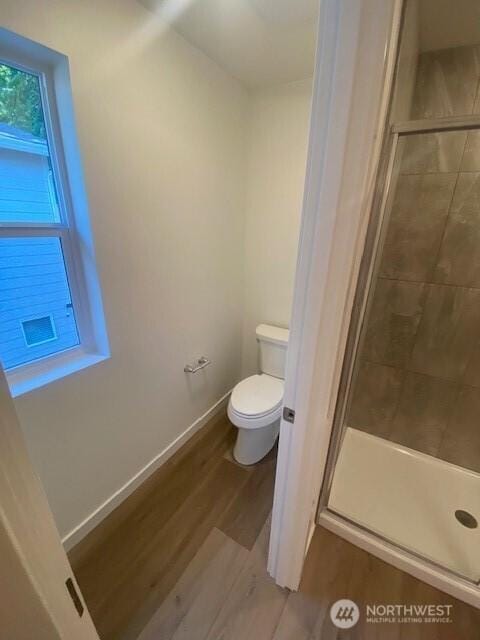 12146 15th Ct SE Unit 13, Lake Stevens, WA 98258 - bathroom with a shower stall, toilet, wood finished floors, and baseboards