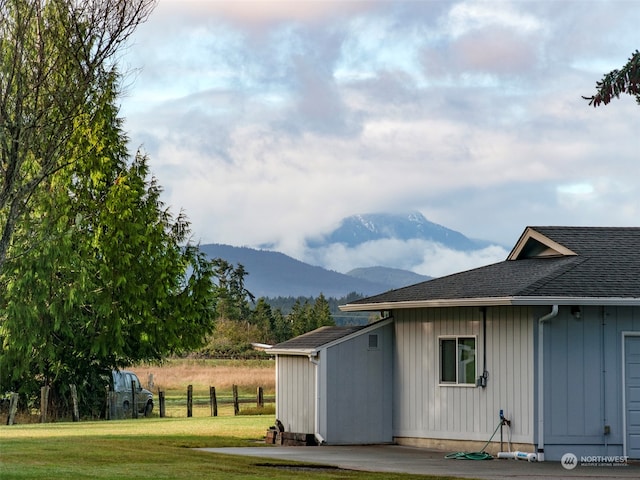 exterior space featuring a mountain view and a yard