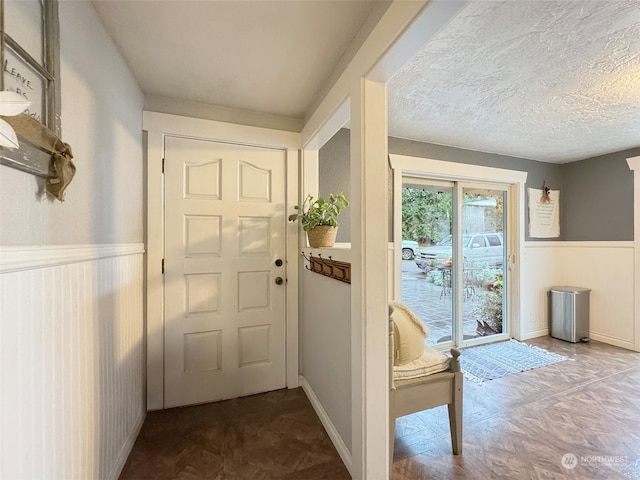 doorway with a textured ceiling