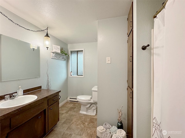 bathroom featuring vanity, a textured ceiling, toilet, and baseboard heating