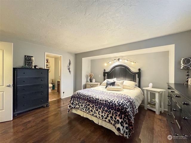 bedroom featuring a textured ceiling and dark hardwood / wood-style floors