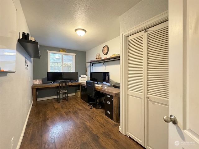 home office featuring a textured ceiling and dark hardwood / wood-style floors