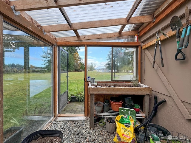 sunroom / solarium with vaulted ceiling with beams