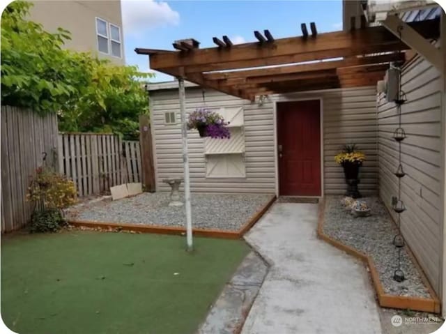 entrance to property featuring a pergola