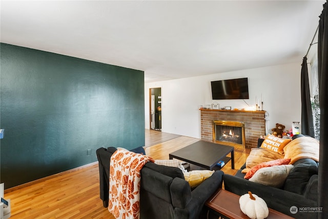 living room with a fireplace and light hardwood / wood-style flooring