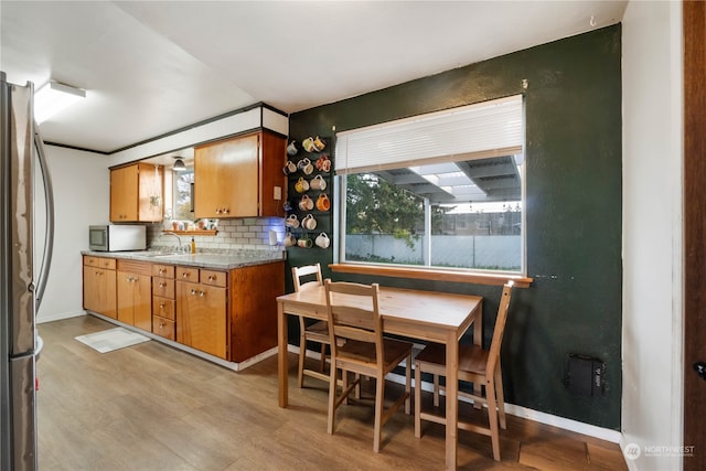 kitchen with decorative backsplash, appliances with stainless steel finishes, and sink