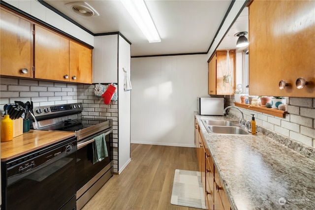 kitchen with sink, dishwasher, light hardwood / wood-style floors, stainless steel electric range, and ornamental molding