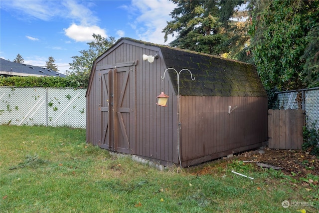 view of outbuilding featuring a lawn