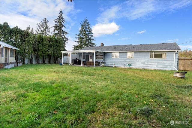 back of house featuring a yard