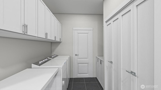 clothes washing area with cabinet space, dark tile patterned flooring, and washing machine and dryer