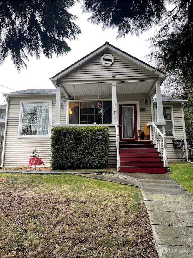 bungalow-style home featuring a front yard