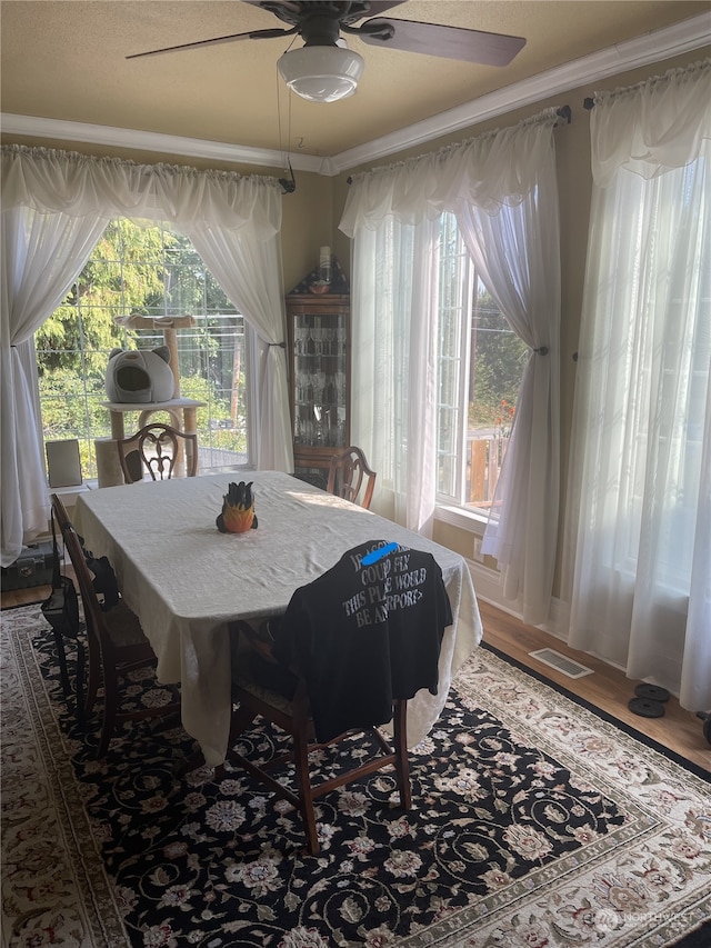 dining room featuring ceiling fan, crown molding, and hardwood / wood-style flooring