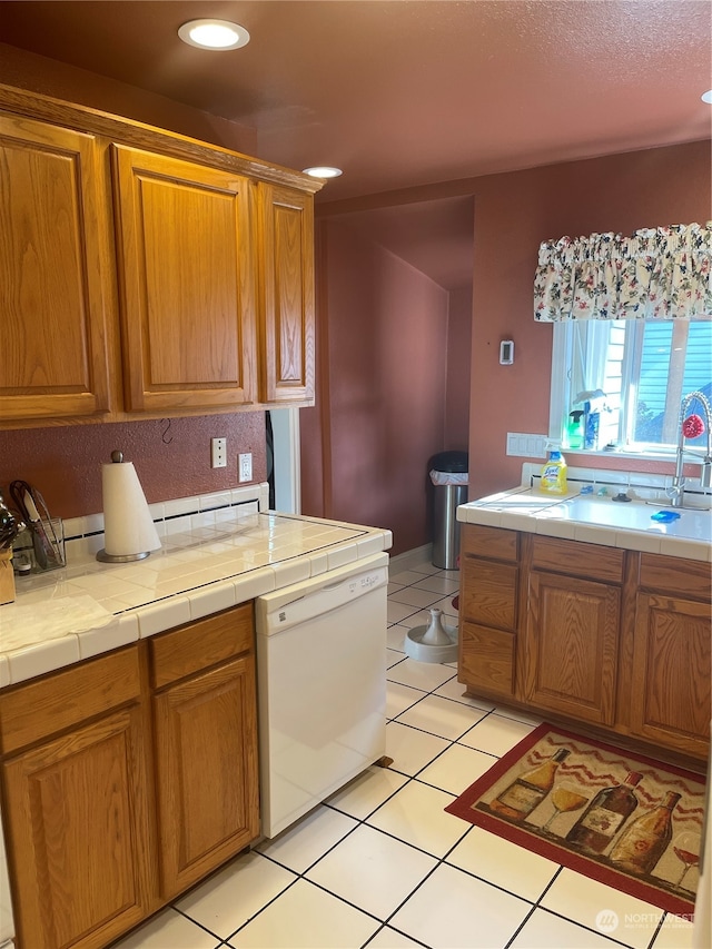 kitchen featuring tile counters, dishwasher, and light tile patterned floors