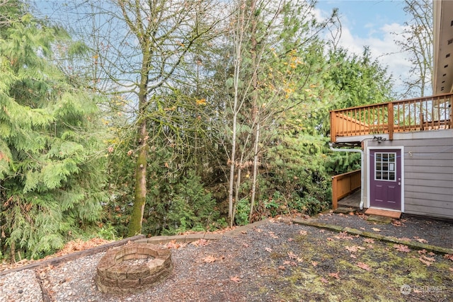 view of yard with a fire pit and a wooden deck