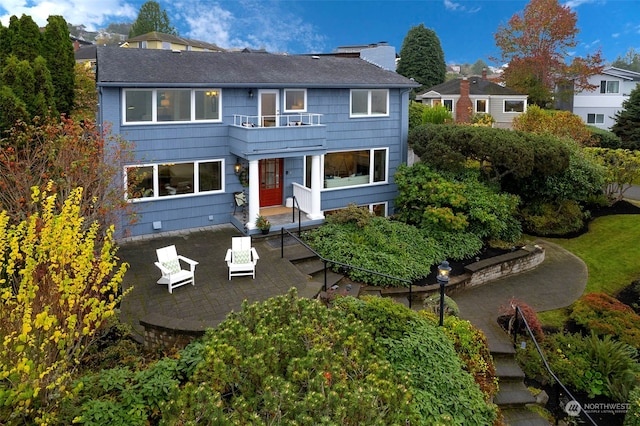 back of house featuring a patio and a balcony