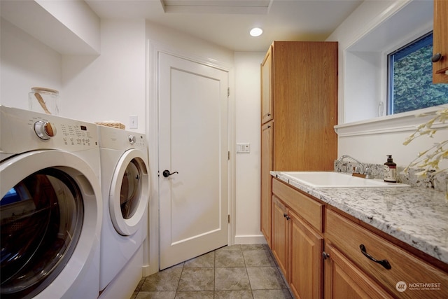 clothes washing area with cabinets, separate washer and dryer, sink, and light tile patterned floors