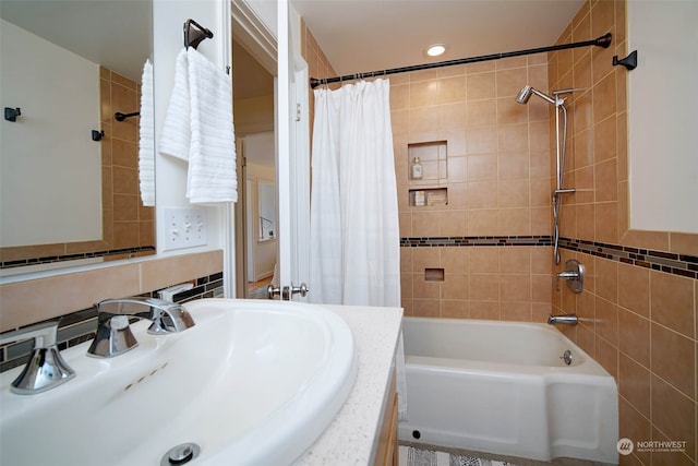 bathroom featuring shower / bath combo, tile walls, and vanity