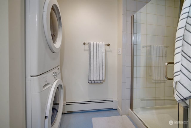 laundry area with baseboard heating and stacked washer and dryer