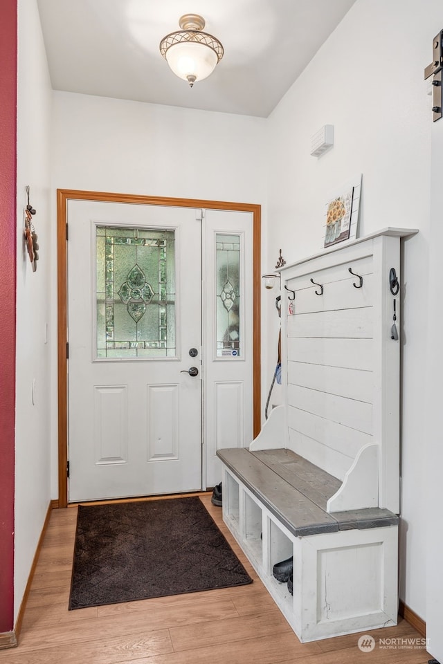 mudroom with a barn door and hardwood / wood-style flooring