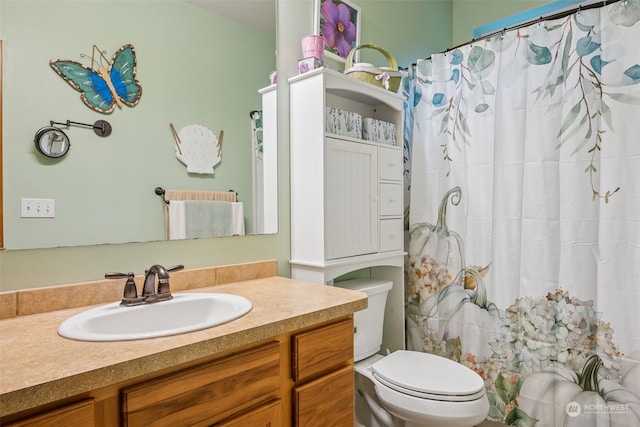 bathroom with vanity, toilet, and walk in shower