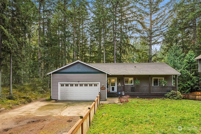 single story home featuring covered porch, a garage, and a front yard