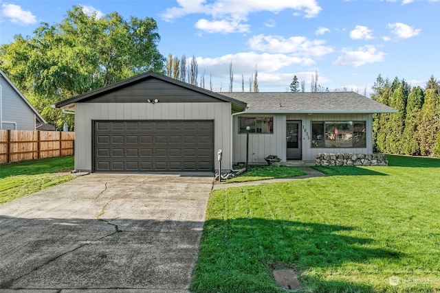 ranch-style home with a front lawn and a garage